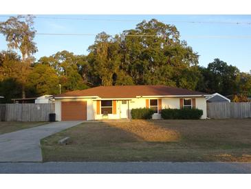 Single story home with attached garage and fenced yard at 5465 Ne 12Th Ave, Ocala, FL 34479