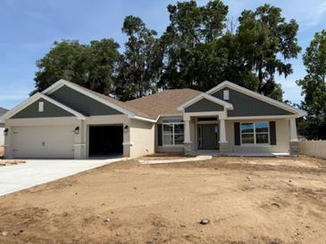 Charming one-story home with a two-car garage and beautifully landscaped front yard at 7 Nw 45Th Loop, Ocala, FL 34470