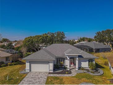 Aerial view of single-story house with gray roof and landscaped yard at 11545 Se 175Th St, Summerfield, FL 34491