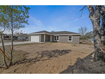 Newly constructed home with gray siding and a two-car garage at 14898 Se 35 Ct, Summerfield, FL 34491