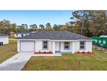 New construction home showcasing a gray roof and white exterior at 15304 Sw 27 Ln, Ocala, FL 34481