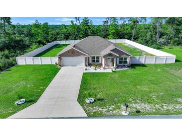 Single-story house with a fenced yard and driveway at 2701 Sw 175Th Loop, Ocala, FL 34473