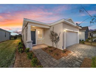 Charming single Gathering home features brick pathway, covered porch, and an attached two-car garage at 5450 Nw 46Th Lane Rd, Ocala, FL 34482