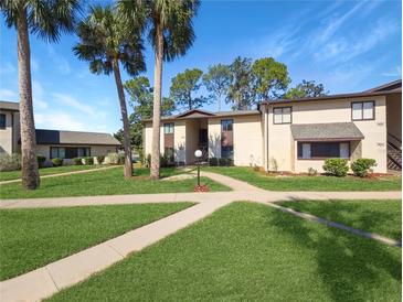 Attractive exterior of condo building with landscaping and walkways at 623 Midway Dr # B, Ocala, FL 34472