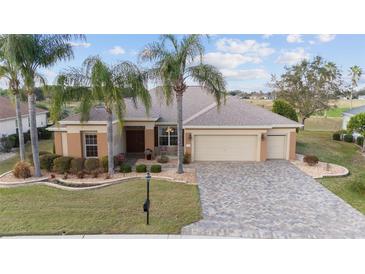 Inviting single Gathering home with a manicured lawn, paver driveway, and two car garage at 9651 Se 137Th Street Rd, Summerfield, FL 34491