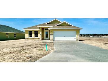 Charming single-story home featuring a two-car garage and a well-manicured lawn in a serene community at 3212 Ne 46Th Ave, Ocala, FL 34470