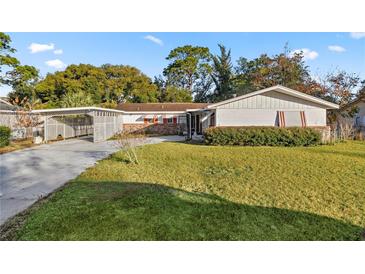 Ranch style home with carport and mature landscaping at 438 Spring Ln, Ocala, FL 34472