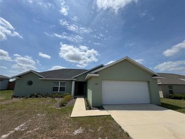 Charming single-story home with a two-car garage and manicured lawn at 6414 Sw 67Th Pl, Ocala, FL 34476
