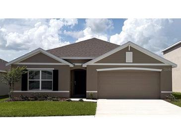 Charming single-story home featuring a two-car garage, neutral paint, manicured lawn, and stylish architectural details at 4763 Sw 88Th Ln, Ocala, FL 34476