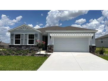 Charming single-story home with stone accents, a two-car garage, and a well-manicured lawn at 6238 Sw 93Rd Loop, Ocala, FL 34476