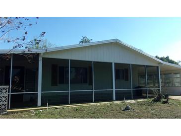 Charming home featuring a large, screened lanai for outdoor enjoyment at 10015 Sw 90Th Ct, Ocala, FL 34481