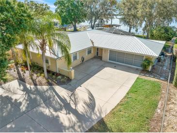 Charming one-story brick home with a well-manicured front yard and a spacious driveway at 10900 Se Timucuan Rd, Summerfield, FL 34491