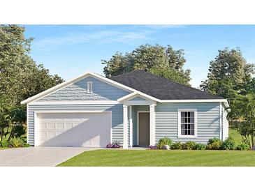 Charming single-story home features a two car garage, light blue siding, and a well-manicured front lawn at 4725 Sw 83Rd Loop, Ocala, FL 34476