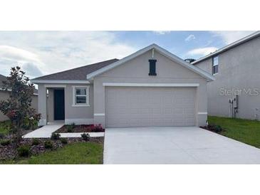 Charming single-story home featuring a two-car garage, neutral color palette, and well-maintained landscaping at 8470 Las Palmas Way, Wildwood, FL 34785