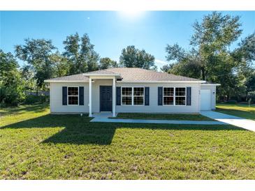 Charming single-story home with a well-maintained lawn and attractive curb appeal at 1 Fisher Lane Way, Ocklawaha, FL 32179