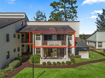 Charming condo featuring dual balconies and lush landscaping at 3437 E Fort King St # 220, Ocala, FL 34470