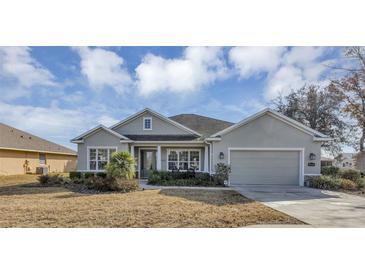 Charming single-story home features a two car garage, manicured landscaping, and beautiful curb appeal at 8751 Sw 57Th Court Rd, Ocala, FL 34476