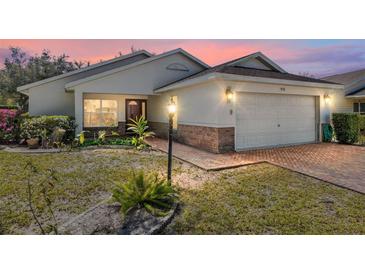Charming single-story home with brick-lined driveway, integrated garage, manicured landscaping, and inviting curb appeal at 9133 Sw 91St Cir, Ocala, FL 34481