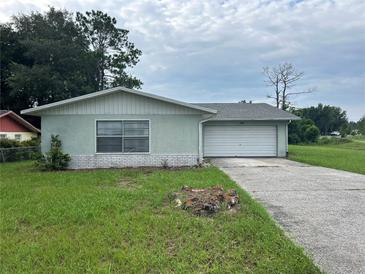 Traditional single-story home featuring a one-car garage and a concrete driveway at 15 Clear Way, Ocala, FL 34472