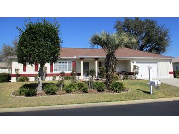 Charming single-story home features well-manicured landscaping and red shutters at 11353 Sw 138Th Ln, Dunnellon, FL 34432