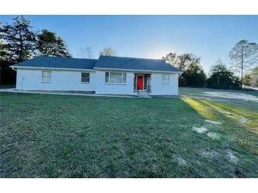 Charming single-story home featuring a bright red front door and spacious green lawn at 15040 Sw 29Th St, Ocala, FL 34481