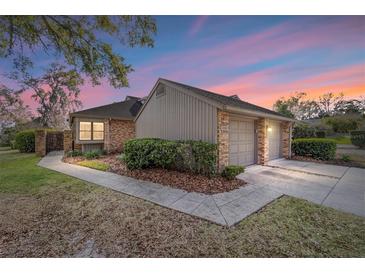 Charming single-story home with well-manicured landscaping, brick accents, and attached two-car garage at 1731 Se Clatter Bridge Rd, Ocala, FL 34471