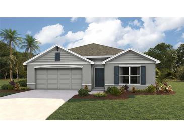 Charming single-story home with landscaped yard, gray exterior, and attached two-car garage at 7161 Se 113Th Ln, Belleview, FL 34420