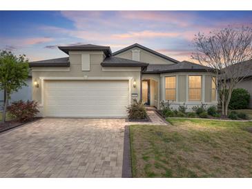 Charming single-story home with a paved driveway, two-car garage and well-maintained landscaping at 9581 Sw 63Rd Loop, Ocala, FL 34481