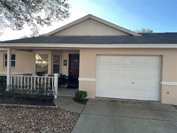 Charming single-story home featuring a one-car garage, covered entry and mature landscaping at 9638 Sw 94Th Ct # A, Ocala, FL 34481