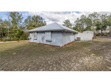 The exterior of this one-story home features a modern metal roof and stucco facade at 12330 Sw 43 St Rd, Ocala, FL 34481