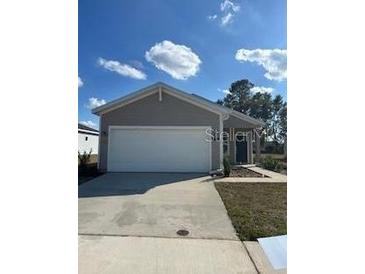 Charming single-story home featuring a spacious two-car garage and inviting front yard at 4724 Nw 11Th St, Ocala, FL 34482