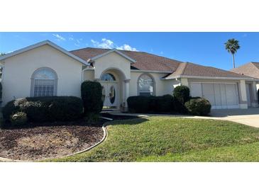 Charming home featuring a manicured lawn and a well-maintained exterior at 5500 Nw 23Rd Pl, Ocala, FL 34482