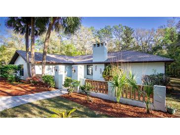 Charming single-story home with landscaped yard and a unique fence in a well-maintained garden at 20260 Sw 95Th St, Dunnellon, FL 34431