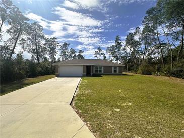 Charming single-story home featuring an attached garage and well-maintained lawn at 3044 Sw 168Th Loop, Ocala, FL 34473