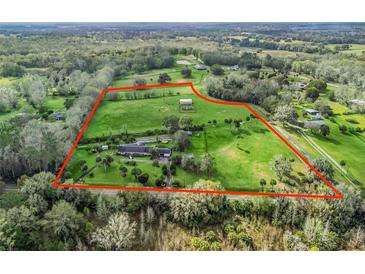 Sprawling estate with lush green pastures outlined in red and mature trees at 6994 Nw 320 Hwy, Micanopy, FL 32667