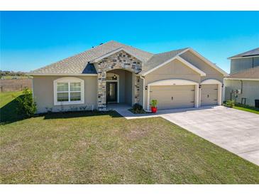 Charming single-Gathering home featuring a stone facade and a three-car garage at 9105 Se 55Th Ter, Ocala, FL 34480