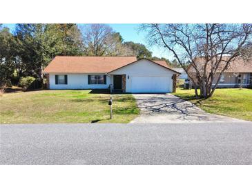 Charming single-story home with a well-maintained lawn and attached garage at 13718 Sw 40Th Cir, Ocala, FL 34473