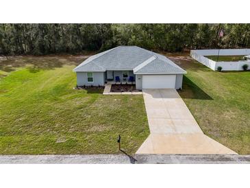 Charming single-story home with well-manicured lawn and inviting front entrance at 1482 Ne 160Th Pl, Citra, FL 32113