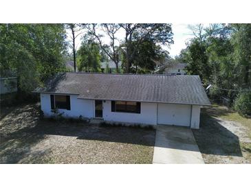 Charming one-story home with a driveway and front yard at 18 Juniper Pass Crse, Ocala, FL 34480