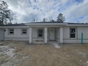 Charming single-story home with a covered front porch and freshly painted exterior at 19 Bay Court Pass, Ocklawaha, FL 32179