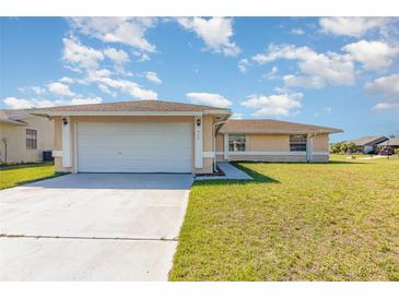 Single-story home displaying attached two-car garage and neutral color palette in a well maintained lawn at 434 Bar Ct, Kissimmee, FL 34759