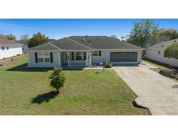 Charming single-story home with well-maintained lawn, driveway, and screened garage at 6196 Sw 84Th Place Rd, Ocala, FL 34476