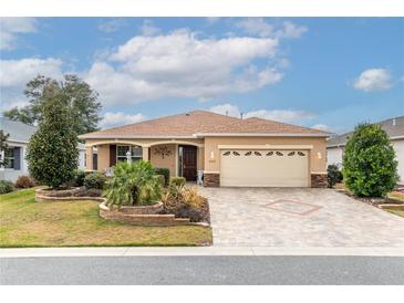 Charming single-story home featuring a well-manicured lawn and a two-car garage with stylish stone accents at 8532 Sw 79Th Ave, Ocala, FL 34481