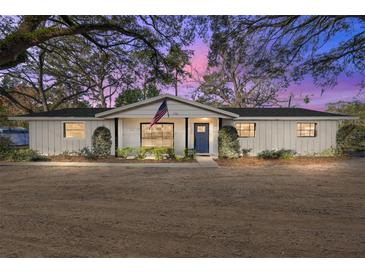 Charming single-story home featuring a freshly painted exterior and an inviting entrance with an American flag at 1126 Ne 34Th Ave, Ocala, FL 34470