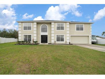 Charming two-story home with manicured lawn and attached two-car garage at 11684 Sw 56Th Ter, Ocala, FL 34476