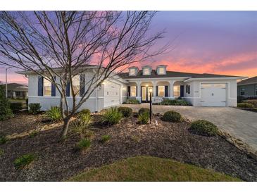 Charming home featuring blue shutters, a brick driveway, and meticulous landscaping at 8864 Sw 85Th Loop, Ocala, FL 34481