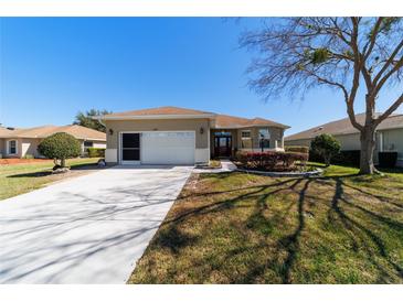 Inviting single-story home featuring a two-car garage and well-maintained landscaping at 9167 Sw 99Th Court Rd, Ocala, FL 34481