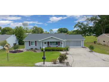 Charming single-story home with well-manicured lawn and attached two-car garage at 10821 Sw 87Th Ter, Ocala, FL 34481