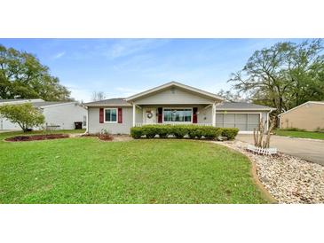 Charming single-story home with well-maintained lawn and attractive landscaping at 10821 Sw 87Th Ter, Ocala, FL 34481