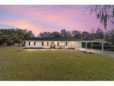 Charming single-story home features a well-manicured lawn and convenient carport at 165 Ne 43Rd Ave, Ocala, FL 34470